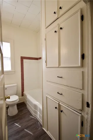 a bathroom with a shower and a toilet