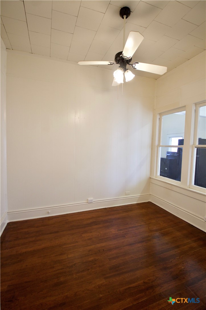 617 North 6th Street Temple, TX 76501 - Photo 26 of 38 a view of a room with wooden floor and a ceiling fan