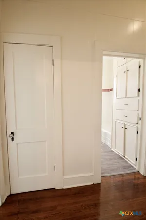 a view of walk in closet with wooden floor