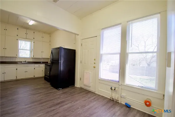 a kitchen with a refrigerator and window