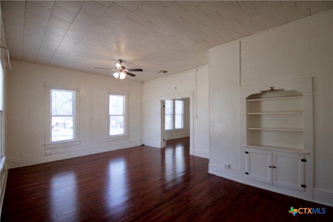 617 North 6th Street Temple, TX 76501 - Photo 4 of 38 a view of an empty room with a window and wooden floor