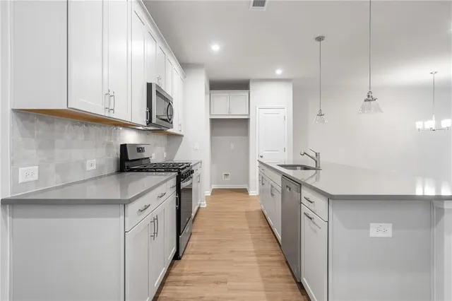 a kitchen with stainless steel appliances granite countertop a sink and cabinets