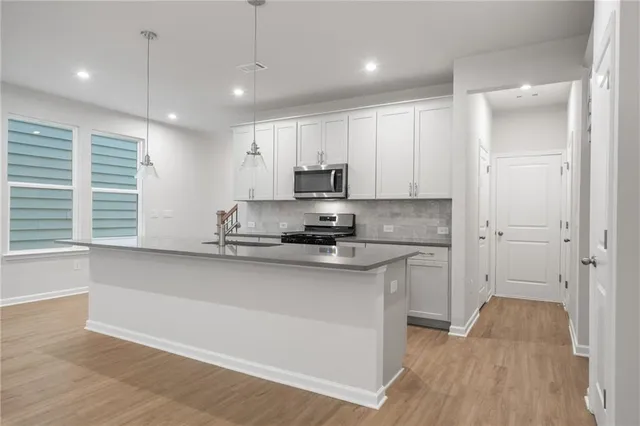 a kitchen with a sink window and cabinets