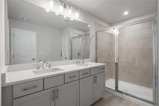 a bathroom with a shower sink and mirror
