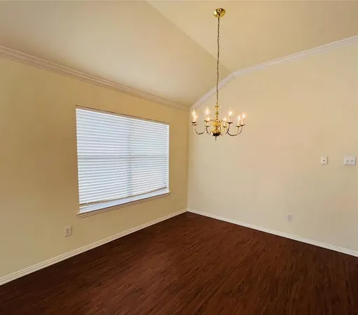 a view of a room with wooden floor and windows