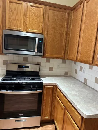a kitchen with granite countertop a stove and a sink