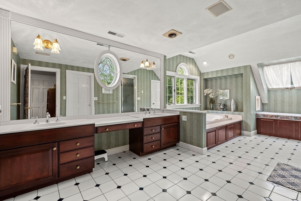 37 Old Planters Road Beverly, MA 01915 - Photo 26 of 42 a large bathroom with a sink mirror and a bathtub