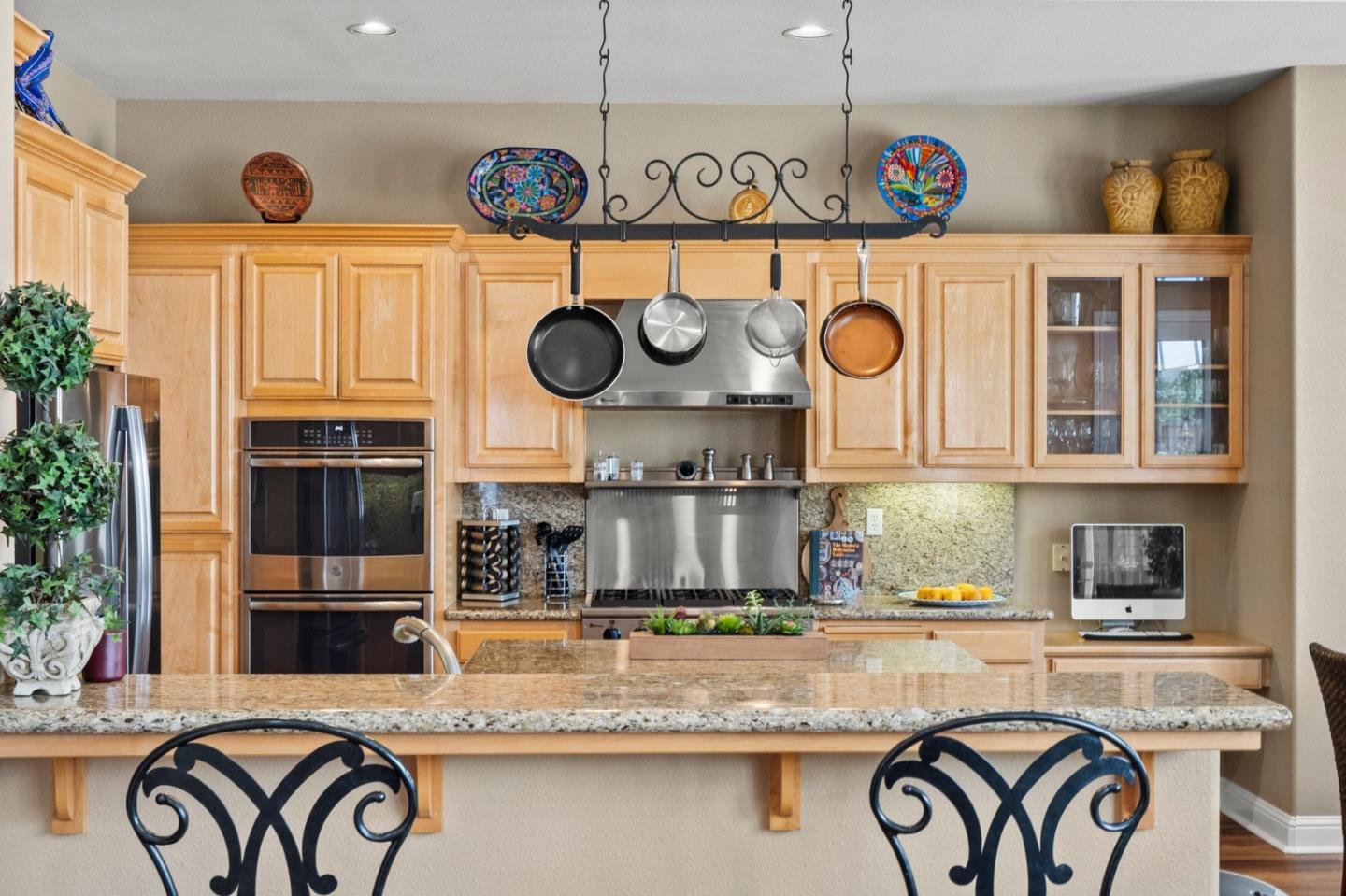 2434 Lakeside Circle Livermore, CA 94550 - Photo 12 of 35 a kitchen with a clock and cabinets