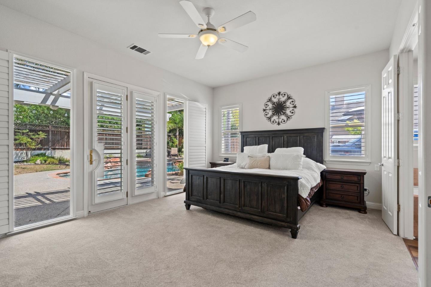2434 Lakeside Circle Livermore, CA 94550 - Photo 22 of 35 a spacious bedroom with a bed window and a balcony