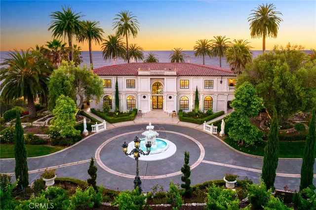 a view of a house with garden space and palm tree