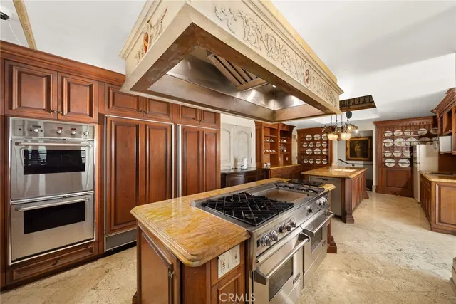 a kitchen with a stove and a refrigerator