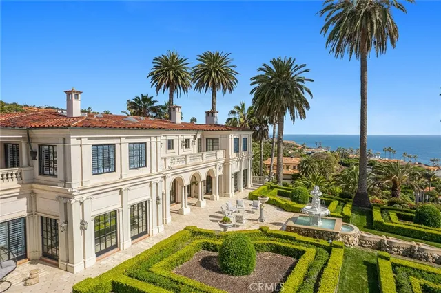 a view of a white house with a sink and yard