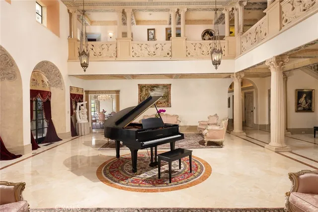 a living room with furniture and a chandelier
