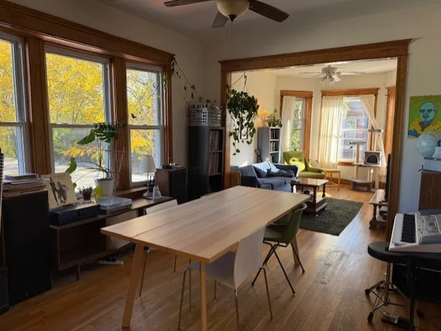 a view of a dining room with furniture and a large window