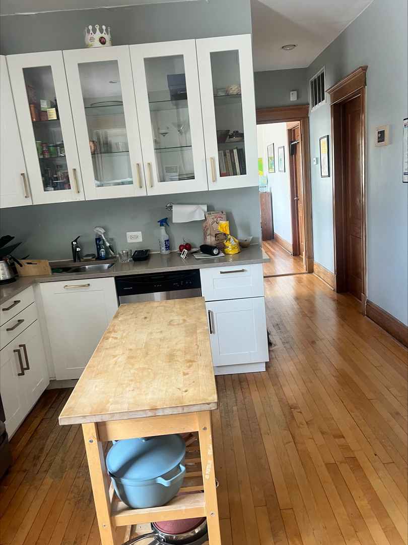 3330 West Evergreen Avenue Chicago, IL 60651 - Photo 5 of 16 a kitchen with granite countertop a stove a sink a refrigerator and wooden floor