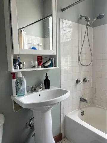 a bathroom with a sink a mirror and a bathtub