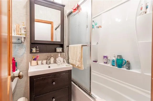 a bathroom with a sink vanity tub and a mirror