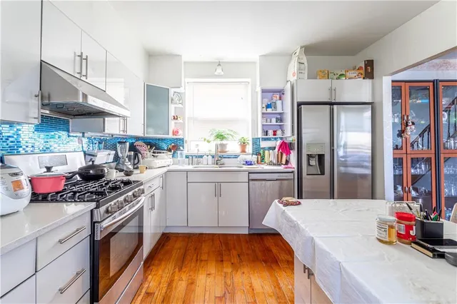a kitchen with a sink stainless steel appliances and cabinets