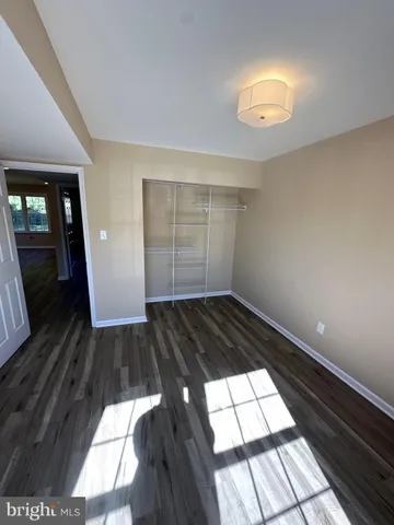 a view of an empty room and wooden floor