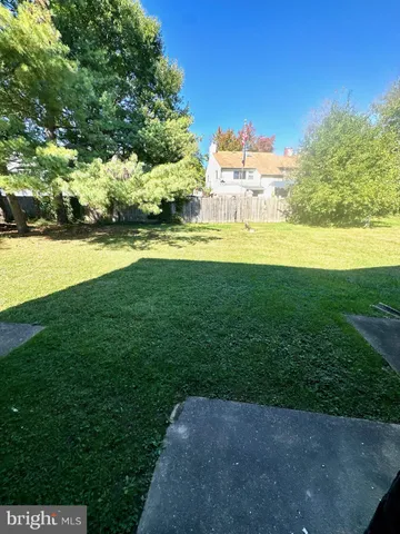 a view of a garden with a building in the background