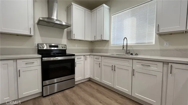 a kitchen with stainless steel appliances granite countertop white cabinets and a granite counter tops