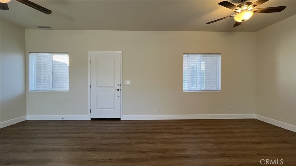 20125 Zuni Road Apple Valley, CA 92307 - Photo 15 of 19 a view of an empty room with wooden floor