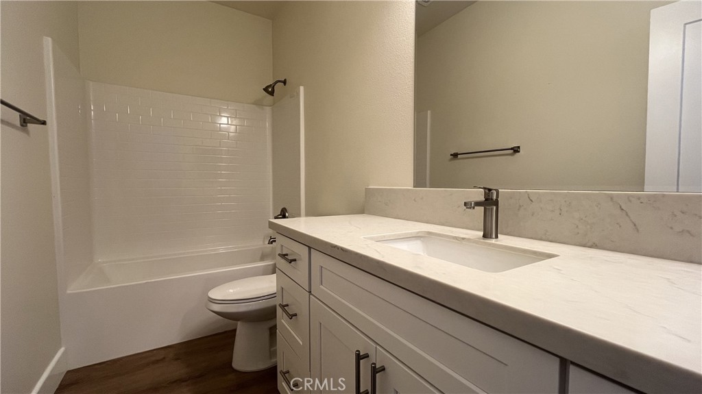 20125 Zuni Road Apple Valley, CA 92307 - Photo 16 of 19 a bathroom with a sink a toilet and shower