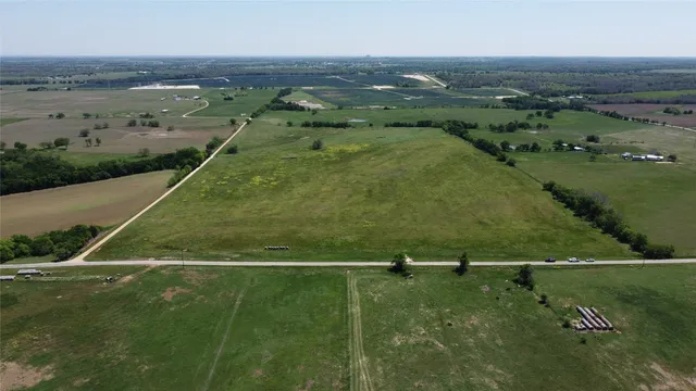 an aerial view of field with beach