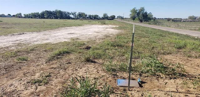 a view of a field with an ocean