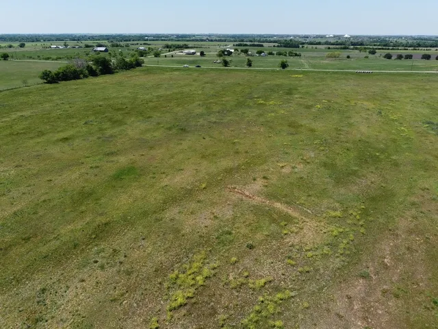 a view of a field with an ocean