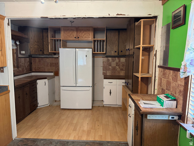 210 South State Street Moroni, UT 84646 - Photo 6 of 23 Kitchen space featuring wood-finish flooring, a white French door refrigerator, and a mix of wood cabinetry