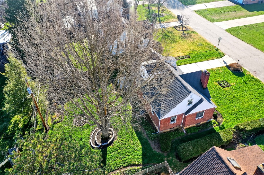 1237 Laurelwood Road Dayton, OH 45409 - Photo 52 of 56 An aerial perspective reveals a charming brick residence nestled in a verdant landscape.