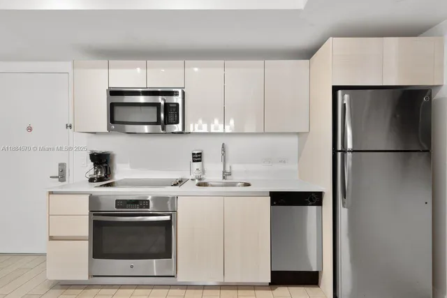a kitchen with a sink stove and refrigerator