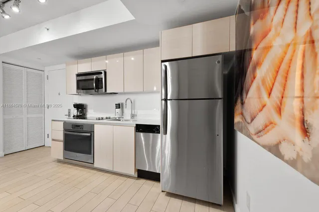 a white refrigerator freezer and a stove sitting inside of a kitchen
