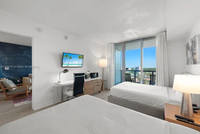 a bedroom with a bed and a lamp