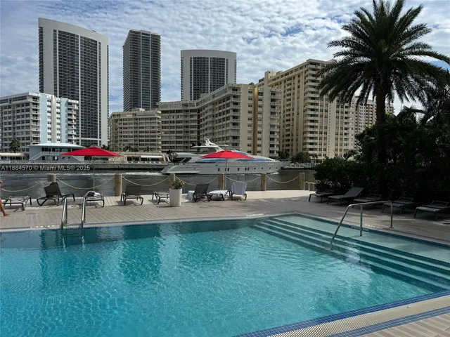 a view of swimming pool with outdoor seating and yard