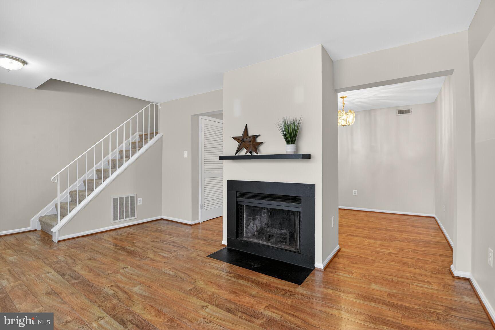 3423 Tendril Court Woodbridge, VA 22192 - Photo 2 of 20 a view of a livingroom with wooden floor and a fireplace