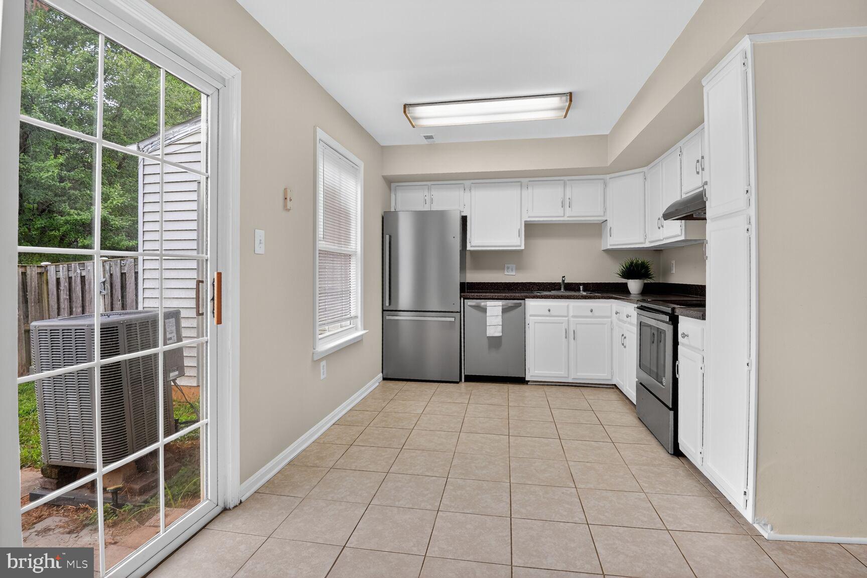 3423 Tendril Court Woodbridge, VA 22192 - Photo 10 of 20 a kitchen with stainless steel appliances a sink and a refrigerator