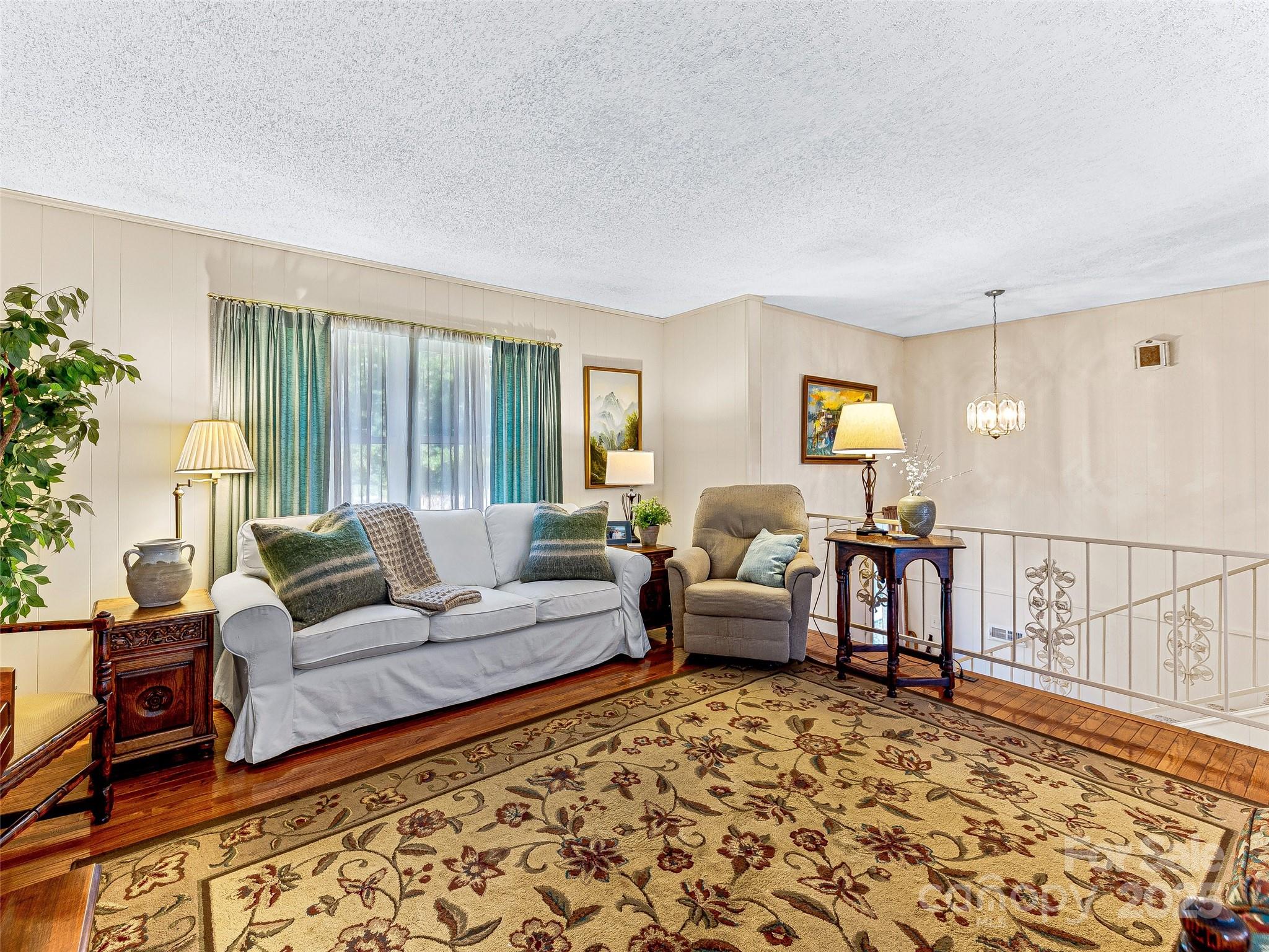 29 Tall Oaks Road Candler, NC 28715 - Photo 12 of 34 a living room with furniture or couch and a large window