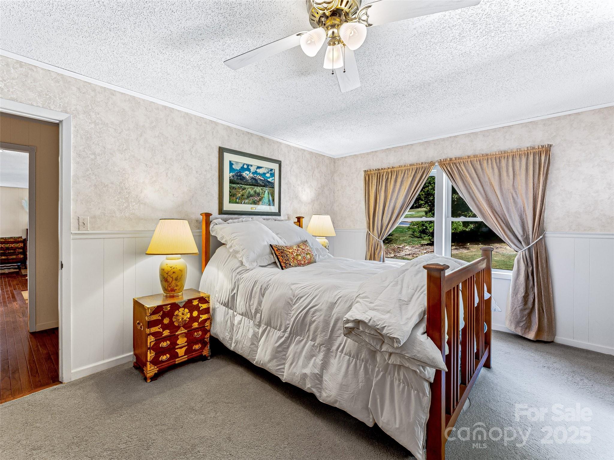 29 Tall Oaks Road Candler, NC 28715 - Photo 13 of 34 a bedroom with a bed and a chandelier