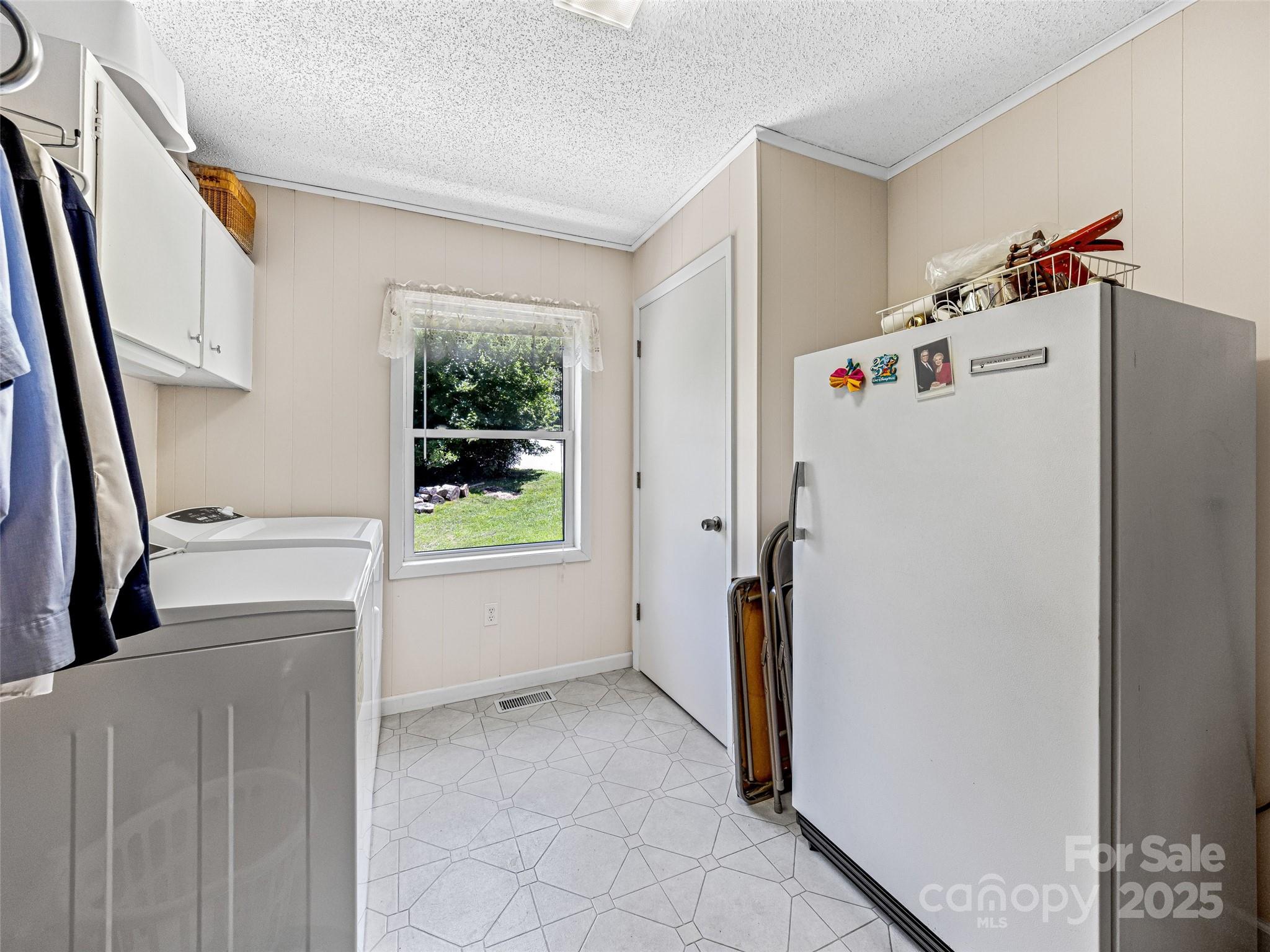 29 Tall Oaks Road Candler, NC 28715 - Photo 18 of 34 a white refrigerator freezer and a window in a room