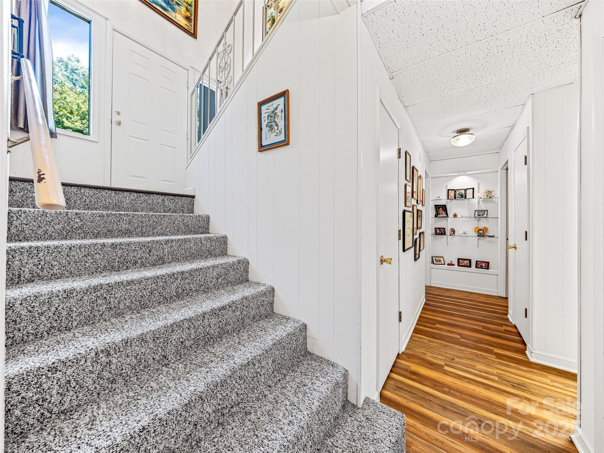 29 Tall Oaks Road Candler, NC 28715 - Photo 20 of 34 a view of a hallway with wooden floor and staircase