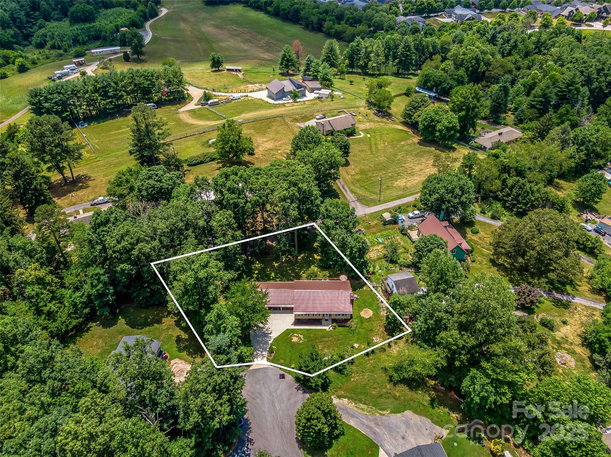 29 Tall Oaks Road Candler, NC 28715 - Photo 2 of 34 an aerial view of residential houses with outdoor space and swimming pool
