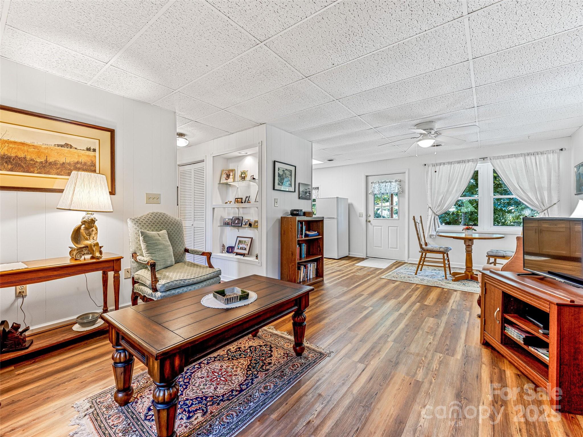 29 Tall Oaks Road Candler, NC 28715 - Photo 22 of 34 a living room with furniture a flat screen tv and a table