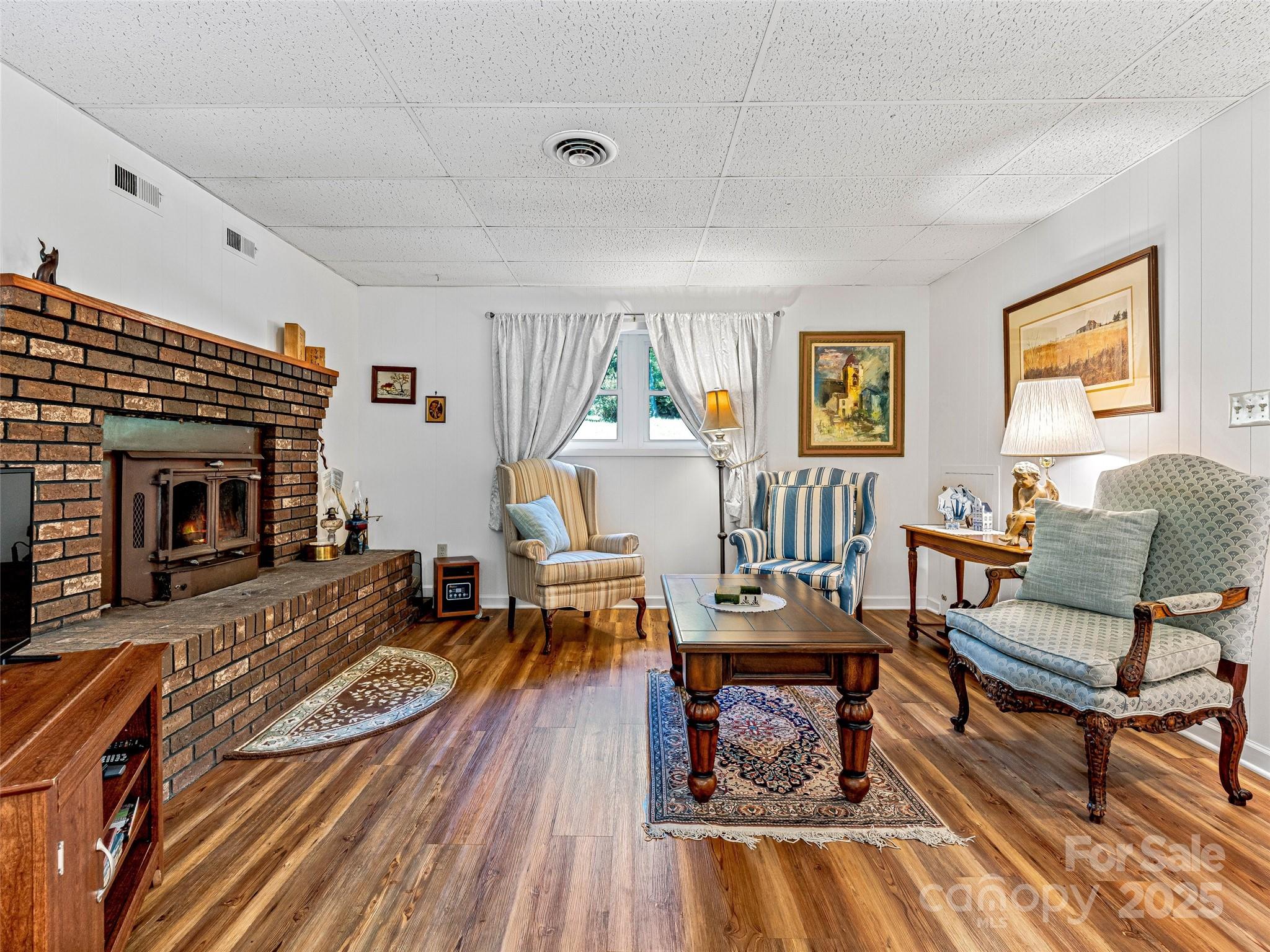 29 Tall Oaks Road Candler, NC 28715 - Photo 23 of 34 a living room with furniture and a fireplace