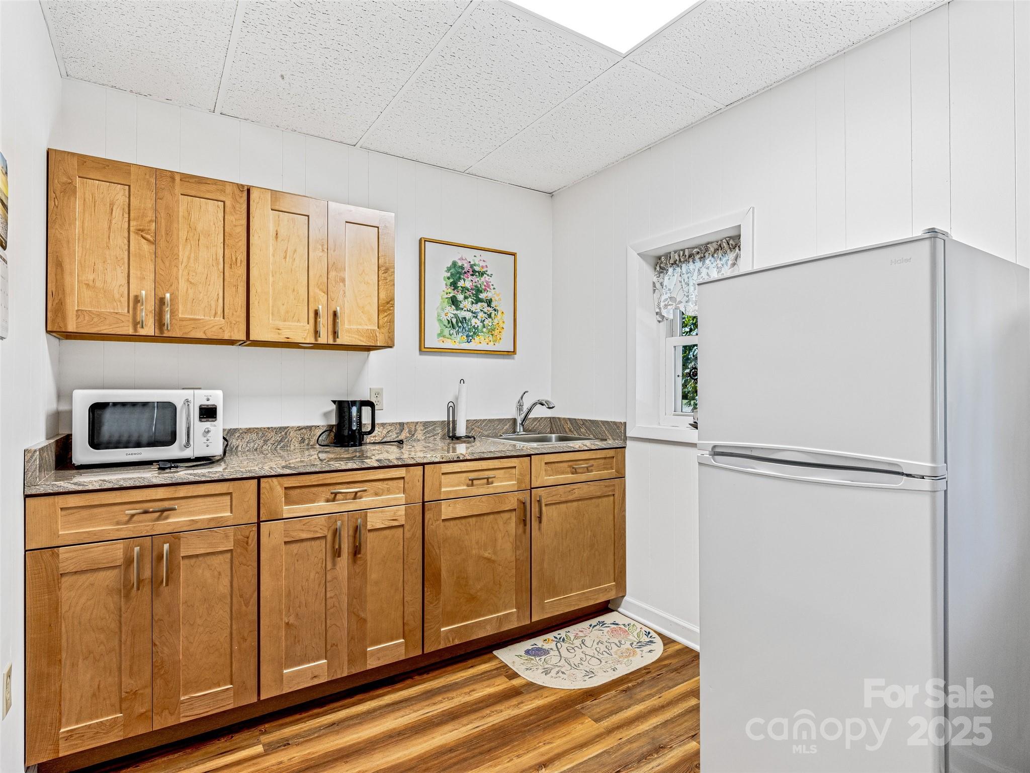 29 Tall Oaks Road Candler, NC 28715 - Photo 25 of 34 a kitchen with stainless steel appliances a refrigerator sink and cabinets