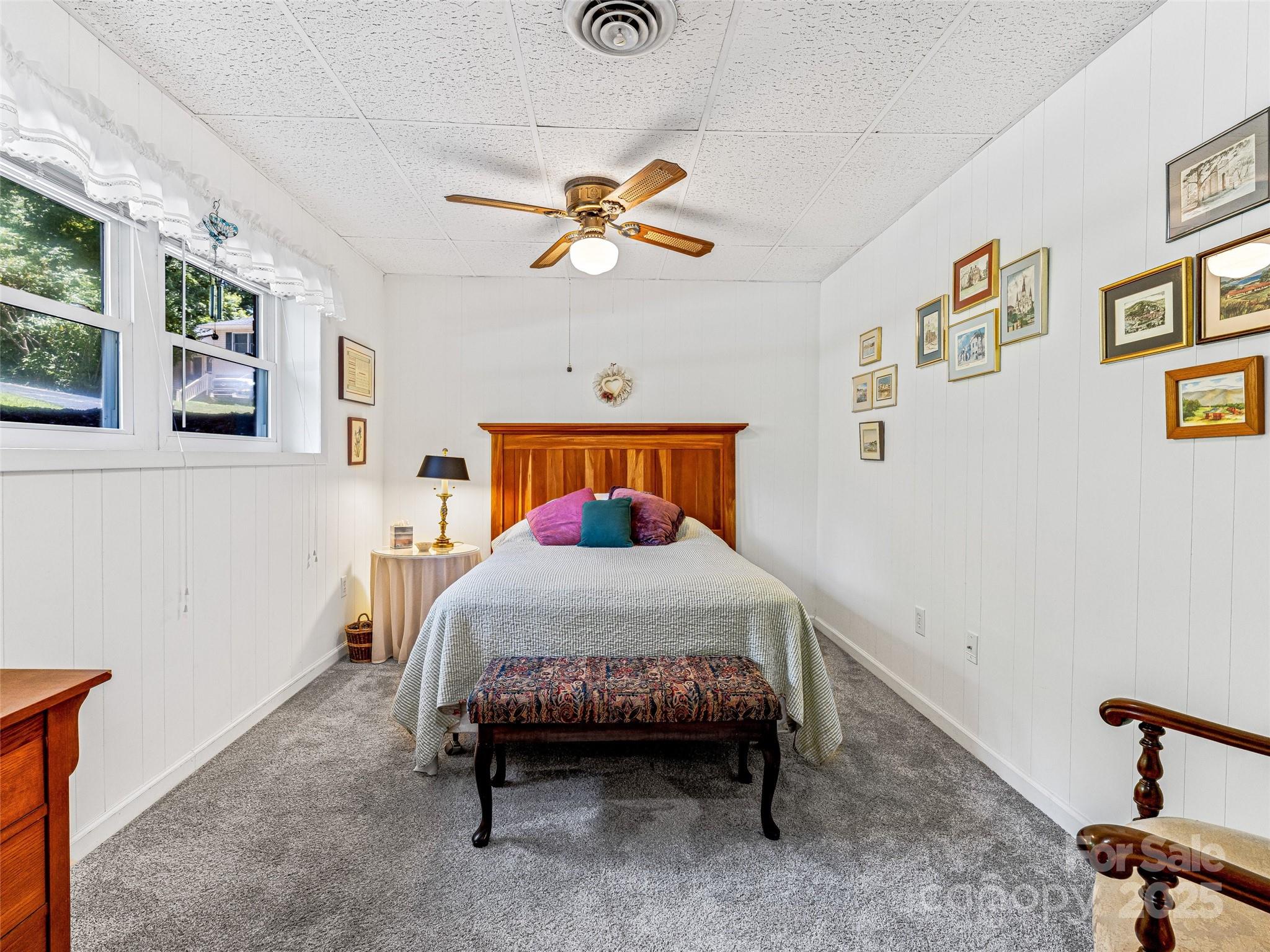29 Tall Oaks Road Candler, NC 28715 - Photo 30 of 34 a bedroom with a bed and painting on the wall
