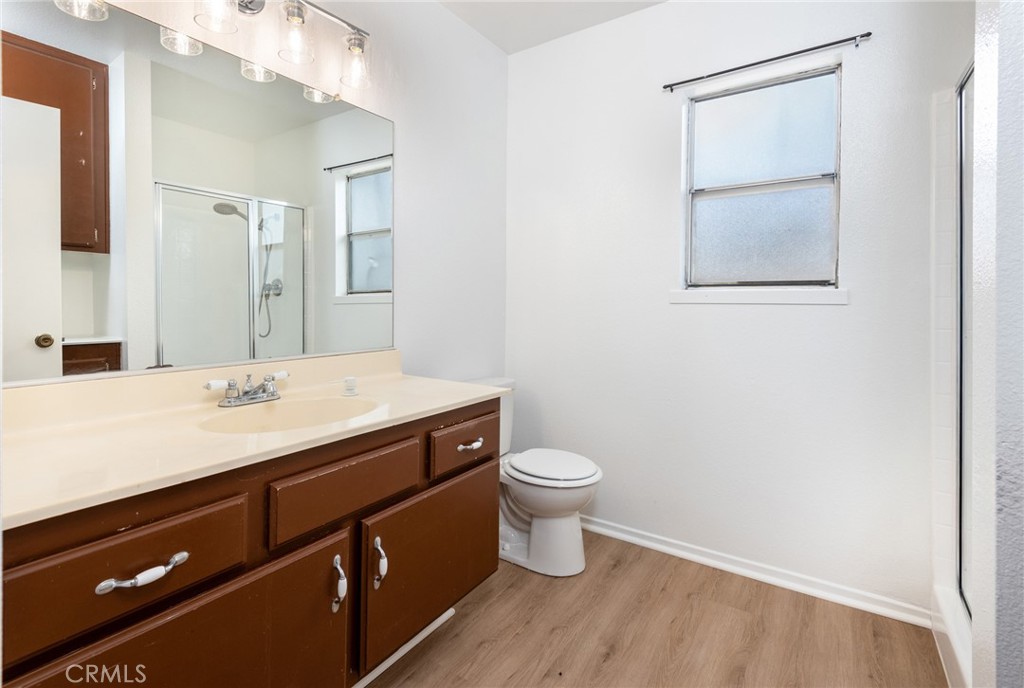 12306 Clover Road Pacoima, CA 91331 - Photo 13 of 18 a bathroom with a sink a toilet and mirror