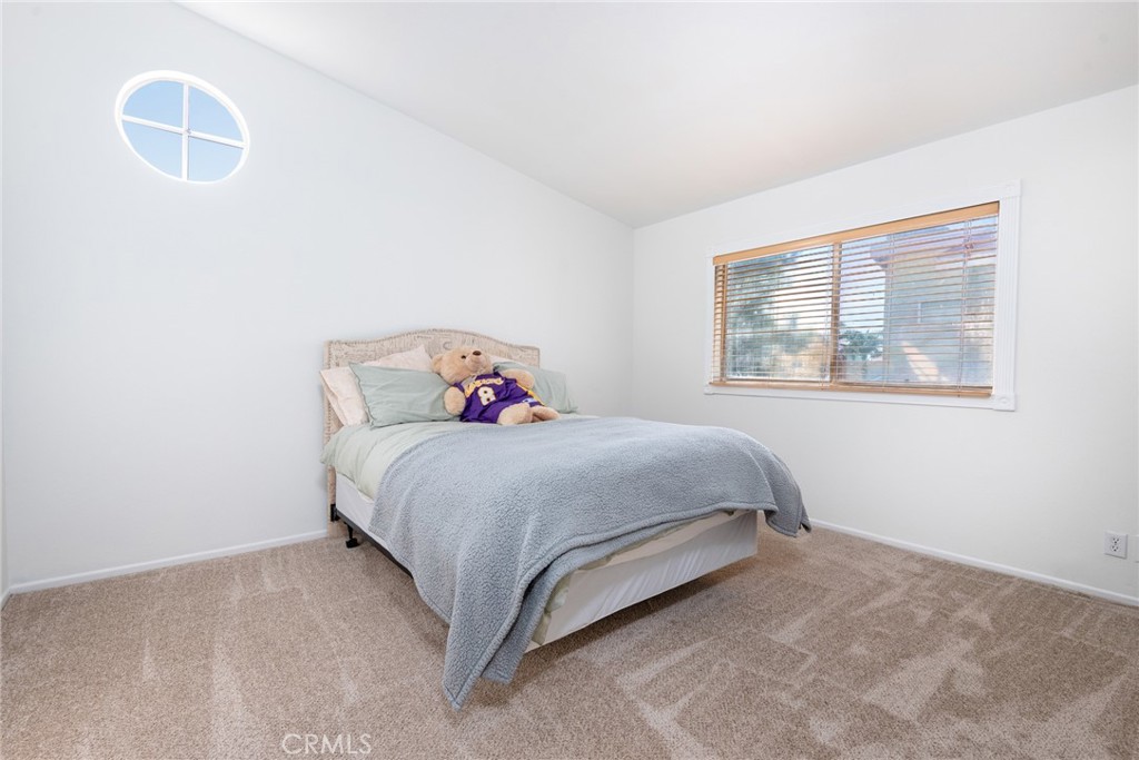 12306 Clover Road Pacoima, CA 91331 - Photo 15 of 18 a bedroom with a bed and a window