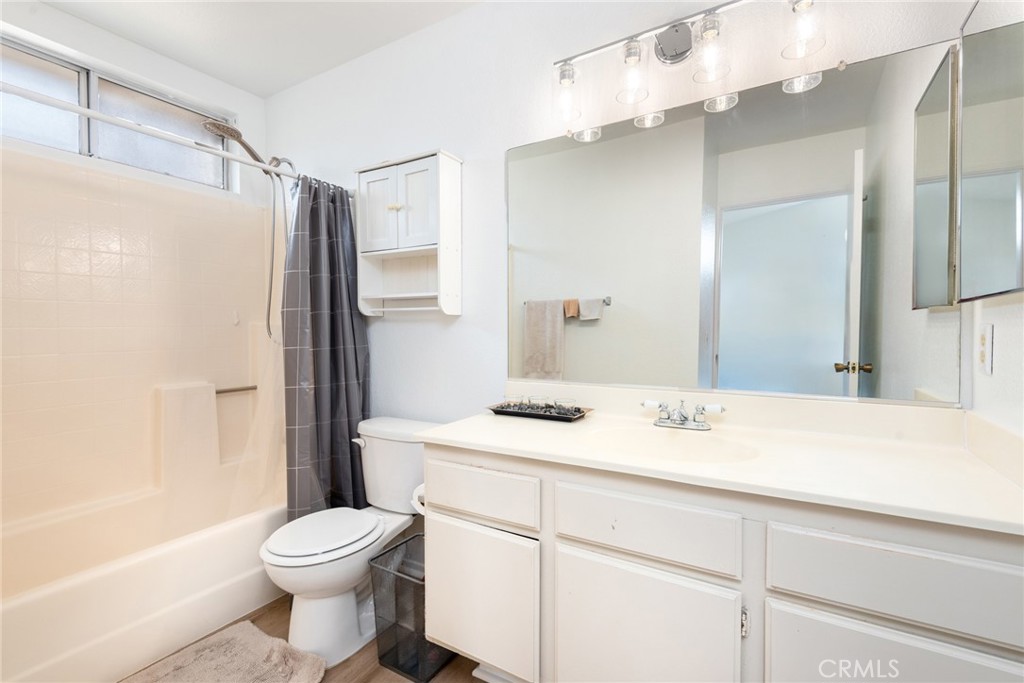 12306 Clover Road Pacoima, CA 91331 - Photo 16 of 18 a bathroom with a sink a toilet and a large mirror